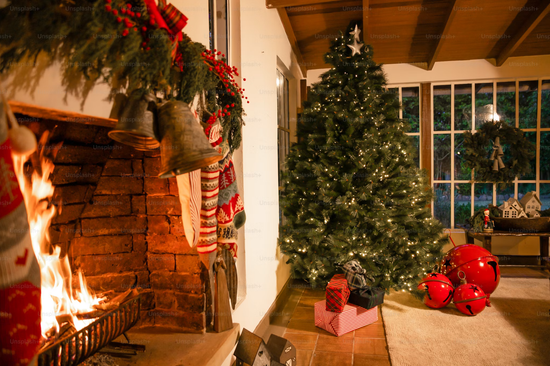 Fireplace with stockings beside a decorated Christmas tree